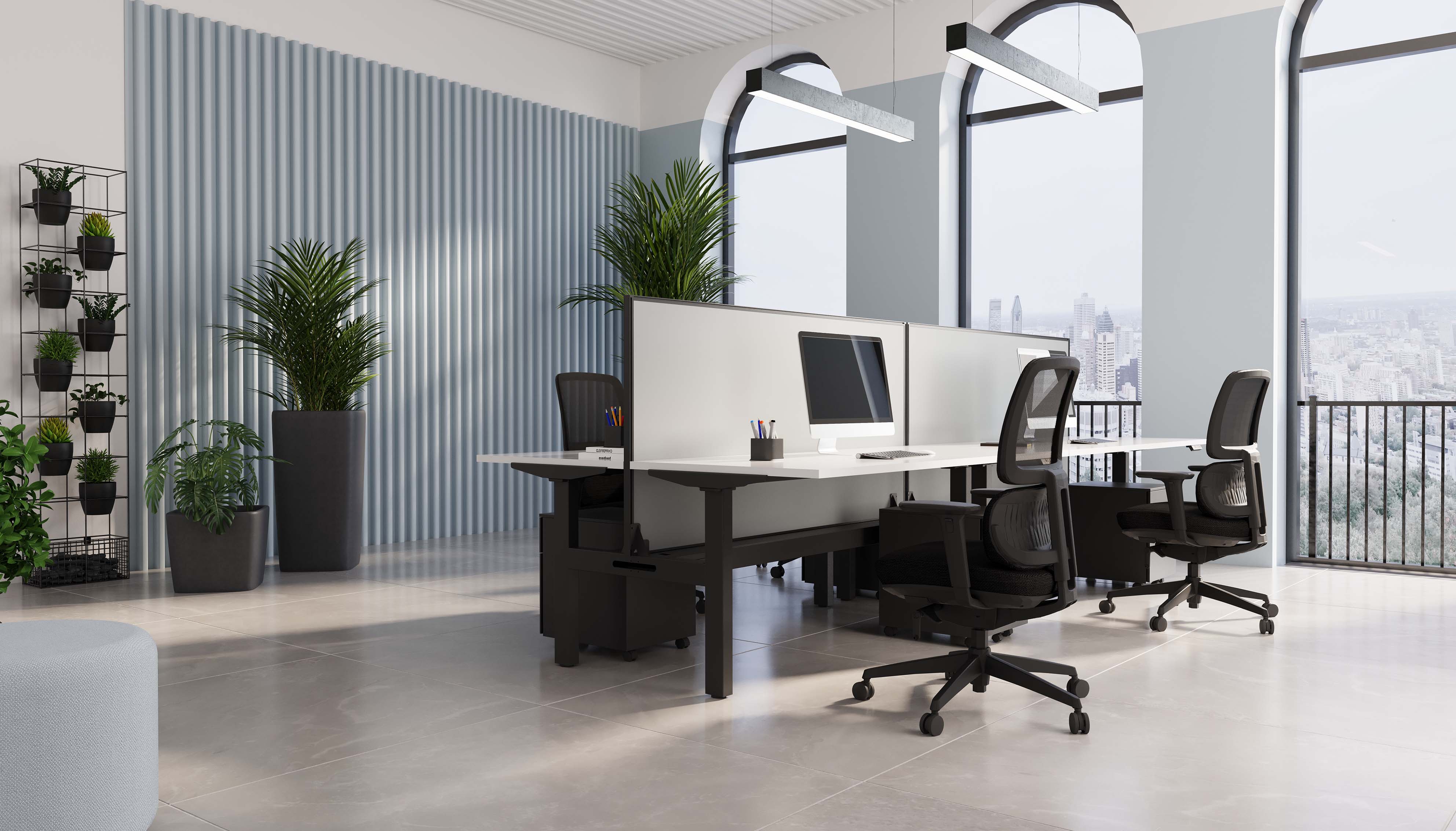 A modern sit-stand height adjustable desk in an office environment